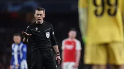 Wasit Clement Turpin saat memimpin laga leg kedua 16 besar Liga Champions 2023/2024 antara Arsenal Melawan Porto di Emirates Stadium, London, Inggris, Rabu (13/03/2024) dini hari WIB. (AFP/Adrian Dennis)