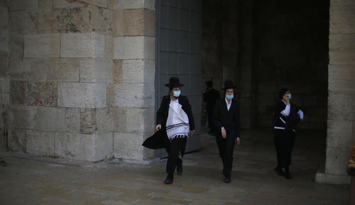 Orang-orang yang mengenakan masker terlihat di luar Kota Tua Yerusalem di tengah pandemi COVID-19 (25/11/2020). (Xinhua/Muammar Awad)