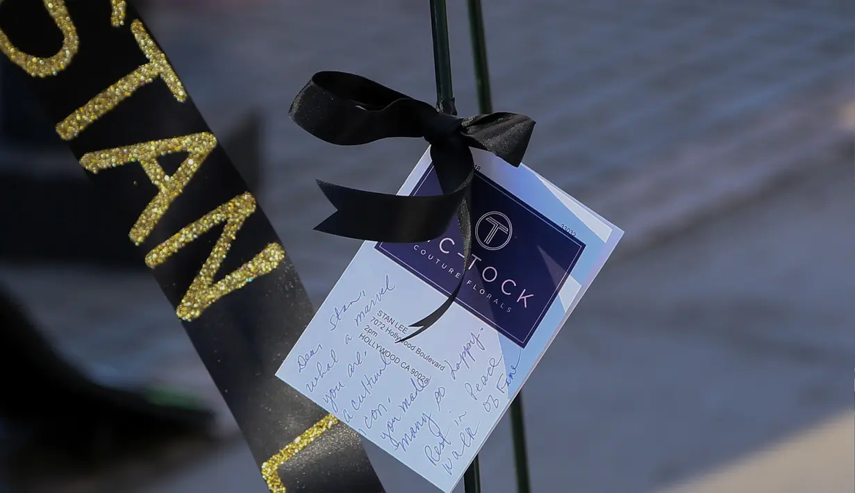 Penggemar meletakkan memorabilia di atas bintang Walk of Fame milik Stan Lee di California, Senin (12/11). Stan Lee, kreator Captain America dan beberapa tokoh superhero Marvel lainnya, meninggal dunia di usia 95 tahun. (Gabriel Olsen/Getty Images/AFP)