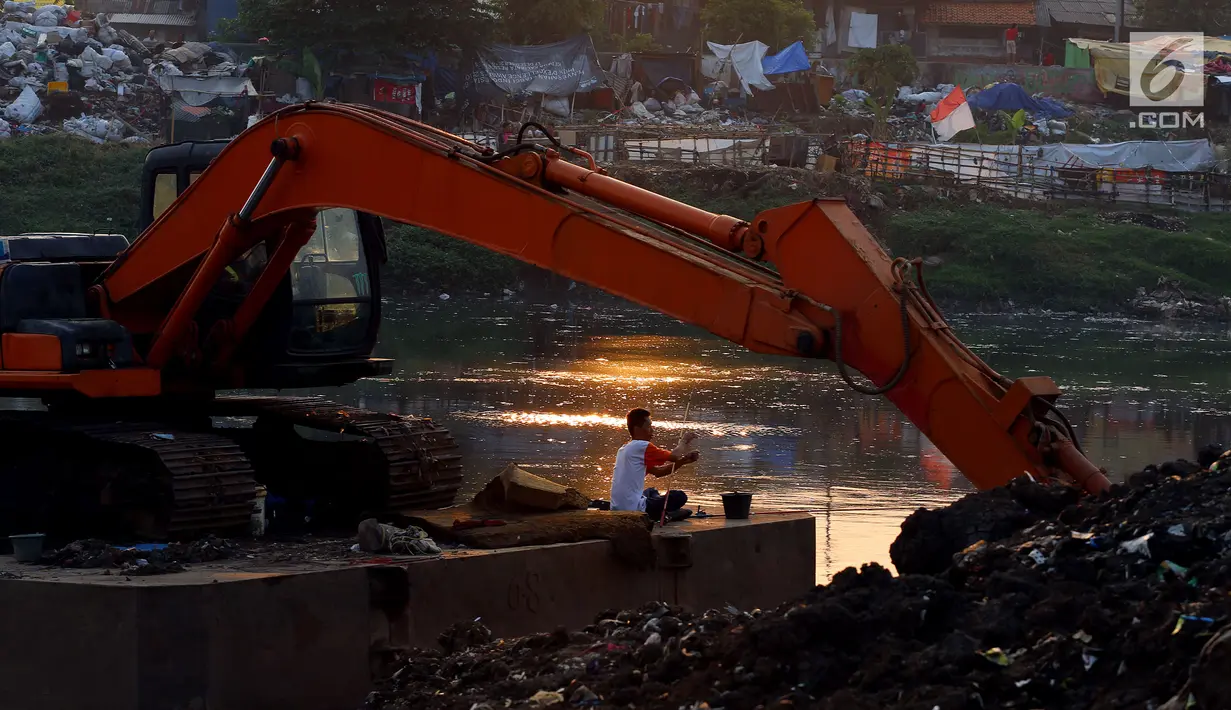 Seorang pria memancing di Kali Ciliwung, Kawasan Tanah Abang, Jakarta, Jum'at (22/9). Karena minimnya lahan terbuka sejumlah warga memanfaatkan Proyek Normalisasi kali untuk beraktivitas dan bermain. (Liputan6.com/JohanTallo)