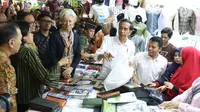 Presiden Jokowi menemani Direktur Pelaksana IMF Christine Lagarde memilih baju koko di salah satu toko Blok A Pasar Tanah Abang, Jakarta, Senin (26/2). Di toko itu Jokowi membantu menanyakan harga dan baju-baju yang ada. (Liputan6.com/Angga Yuniar)