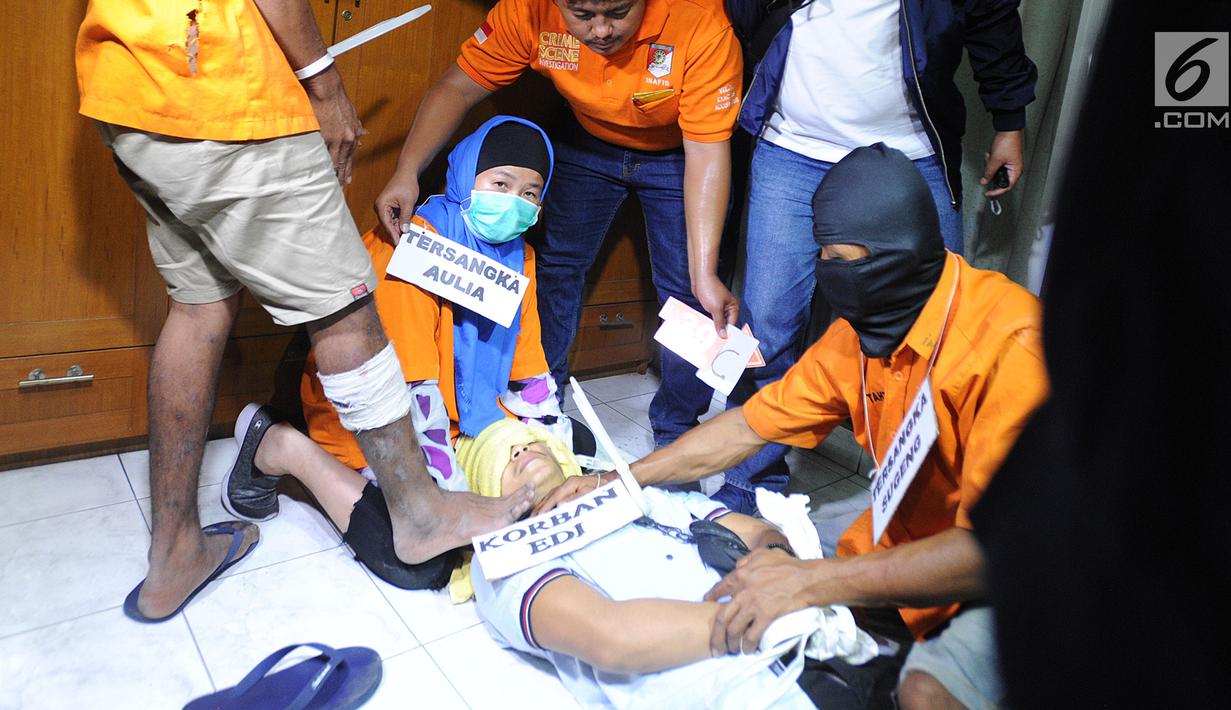 Tersangka Aulia Kesuma (kiri) saat rekonstruksi pembunuhan suami dan anak tirinya di Jalan Lebak Bulus 1, Cilandak, Jakarta Selatan, Kamis (5/9/2019). Aulia dibantu dua eksekutor membekap korban yang sudah pulas akibat minuman bercampur obat tidur yang diberikan sebelumnya. (merdeka.com/Arie Basuki)