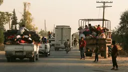 Warga melarikan diri menggunakan sejumlah mobil saat pasukan Turki memburu milisi Kurdi di Ras al Ayn, Suriah, Rabu (9/10/2019). Turki melancarkan serangan udara dan tembakan artileri terhadap milisi Kurdi di sepanjang perbatasan Suriah. (AP Photo/Baderkhan Ahmad)