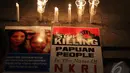 aktivis dari "Papua Itu Kita" melakukan aksi bakar lilin meminta Presiden Jokowi untuk bersuara tentang penembakan dan bentrokan tersebut, Jakarta, Kamis (18/12/2014). (Liputan6.com/Faizal Fanani)