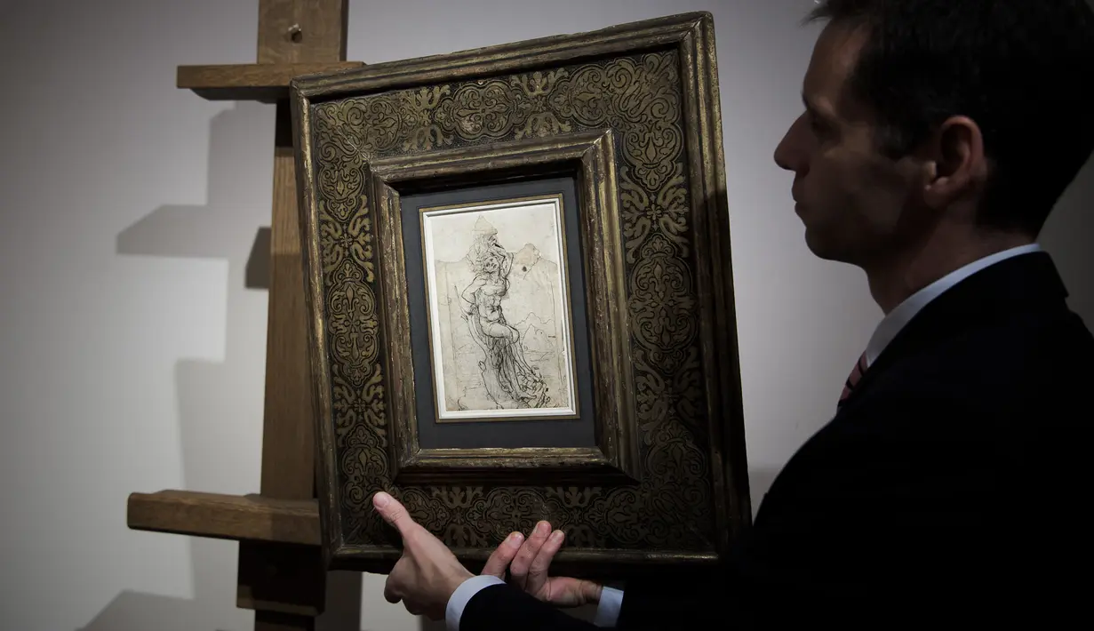 Seorang anggota Rumah Lelang Tajan memperlihatkan gambar sketsa karya Leonardo da Vinci sebelum dilelang di Paris, Prancis (13/12). Karya tersebut bernilai sekitar 16 juta USD. (AFP/Philippe Lopez)