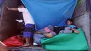 Pengungsi Gunung Agung beristirahat di atas truk yang terparkir di Klungkung, Bali, Sabtu (23/9). Sebagian pengungsi merasa lebih nyaman tinggal sementara di atas truk dibandingkan dengan ruangan dan tenda yang telah disediakan (AP Photo/Firdia Lisnawati)