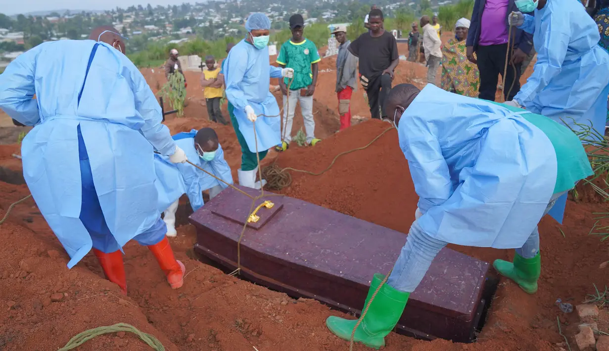 Orang-orang yang mengenakan pakaian pelindung bersiap menurunkan peti jenazah seorang anak berusia enam tahun yang meninggal akibat Ebola, ke dalam liang lahat di Bunia, Provinsi Ituri, Kongo timur, Selasa, 18 Agustus 2026. (Foto AP/Dieudonne Dirole)