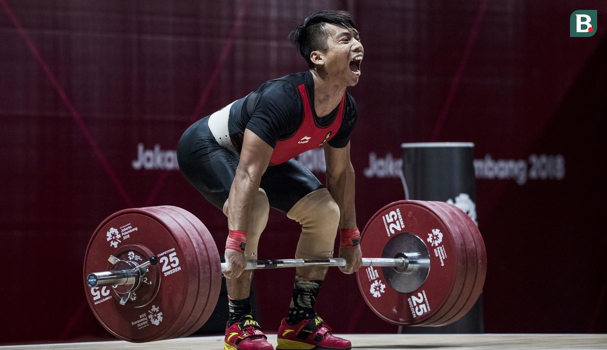 Lifter Indonesia, Deni, saat berlaga pada Asian Games di JIExpo, Jakarta, Rabu (22/8/2018). Deni memastikan lolos ke final setelah berhasil membukukan poin terbaik dengan total angkatan seberat 318 kg. (Bola.com/Vitalis Yogi Trisna)