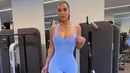 Terlihat di tempat gym, Kim Kardashian berpose mengenakan body suit berwarna biru muda. Ia memadukannya dengan sneakers favorit bernuansa abu-abu dan hitam. Foto; Instagram.