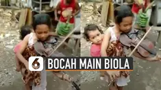 Baru-baru ini beredar video bocah perempuan bermain biola sambil menggendong adiknya. Banyak netizen yang berkomentar supaya ia bisa bertemu dengan Addie MS.