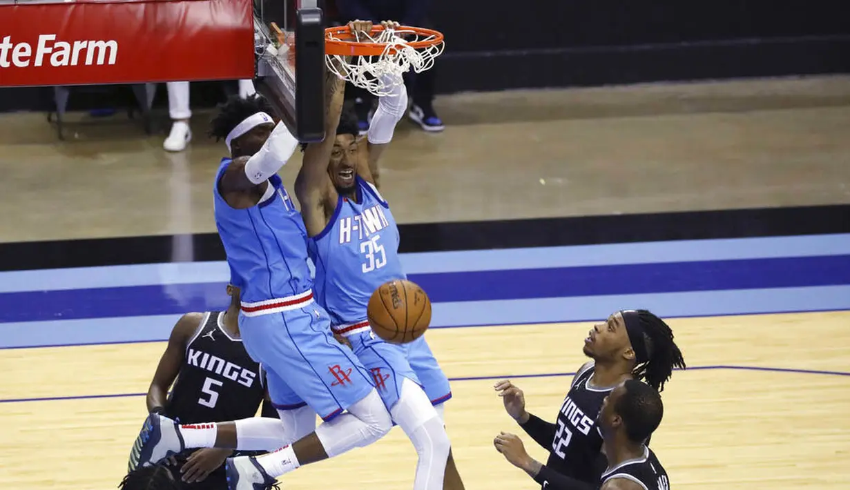 Pebasket Houston Rockets, Christian Wood, memasukan bola saat melawan Sacramento Kings pada laga NBA, Jumat (1/1/2021). Houston Rockets menang dengan skor 122-119. (AP/Richard Carson)
