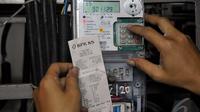 Petugas saat memeriksa tarif meteran listrik di Rusun Benhil, Jakarta, Jumat (9/1/2015). (Liputan6.com/Johan Tallo)