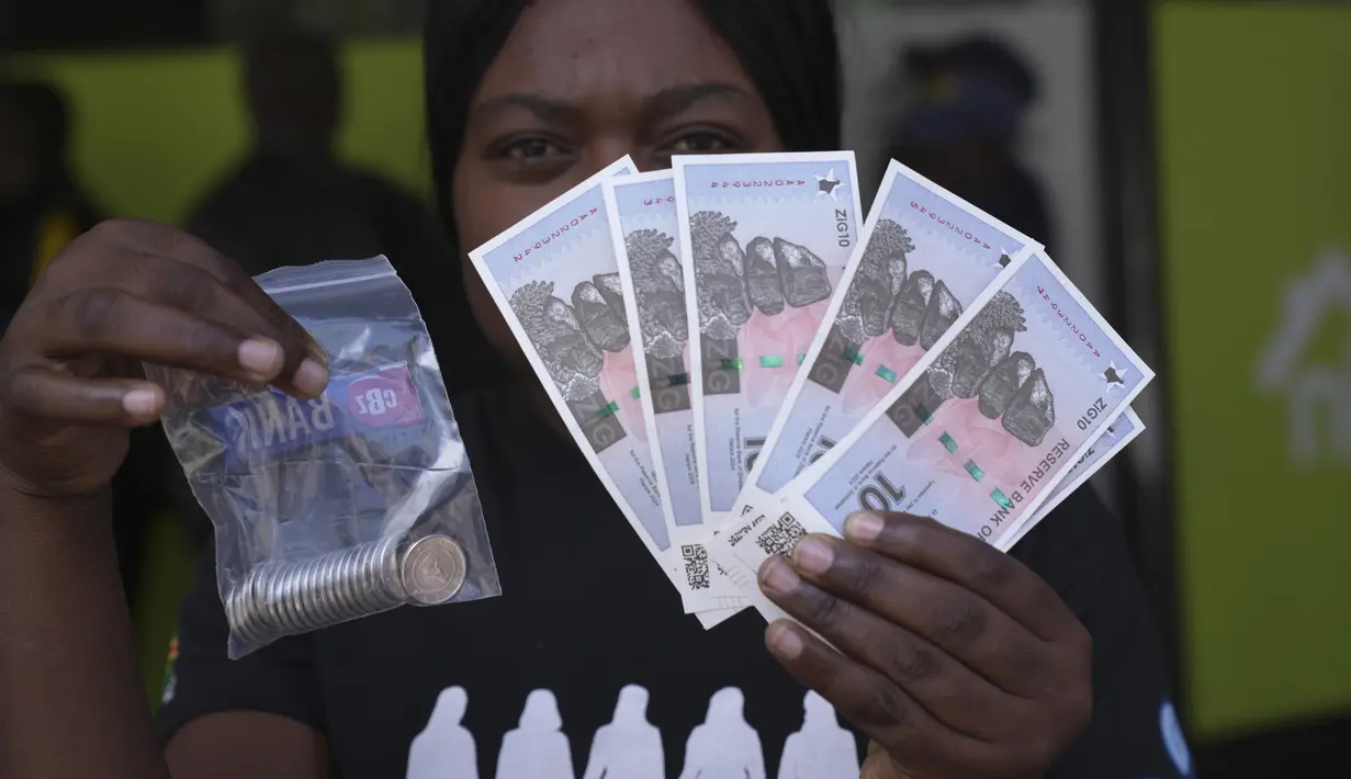 Seorang perempuan memegang uang kertas dan koin Zimbabwe baru yang disebut ZiG, di jalan-jalan Harare, Zimbabwe, Selasa, 30 April 2024. (AP Photo/Tsvangirayi Mukwazhi)