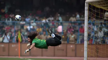 Kiper asal Kolombia ini meski masih dalam upaya menyelamatkan gawang, tapi aksi Rene Higuita benar-benar gila. Apalagi, kalau bukan tendangan kalajengking untuk menghalau bola yang akan masuk ke gawangnya sendiri. (AFP PHOTO/Dibyangshu SARKAR)