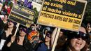 Anggota organisasi feminis membawa poster saat menggelar aksi memperingati Hari Internasional untuk Penghapusan Kekerasan terhadap Perempuan di Valparaiso, Chile, Rabu (25/11). (REUTERS/Rodrigo Garrido)
