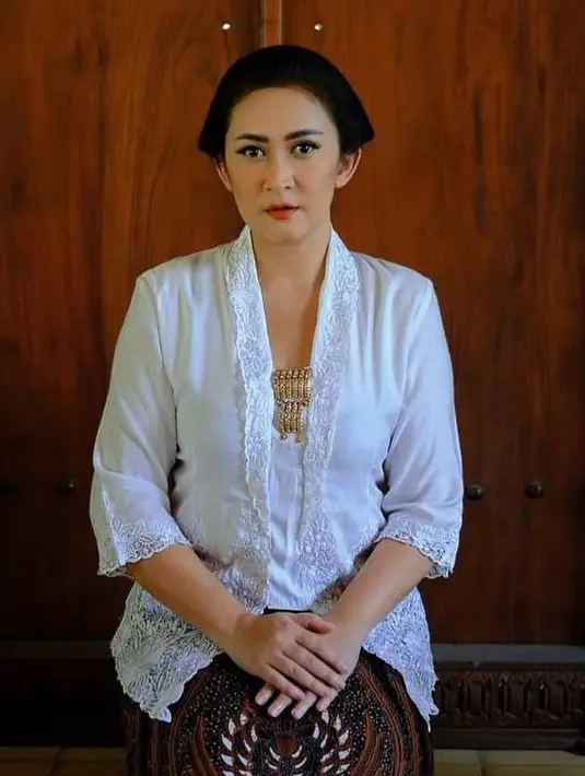 Nafa kembali mengenakan kebaya putih kali ini dengan lengan 3/4 dengan list brokat. Dipadukan bros keemasan dan kain batik coklatnya. [@nafaurbach]