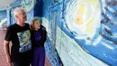 Nancy Nemhauser dan Lubomir Jastrzebski berpose dekat mural di rumah mereka di Florida, 18 Juli 2018. Pada Februari  2018, pasangan suami istri  itu menggugat kota karena dinilai melanggar hak konstitusional mereka untuk bebas berekspresi. (AP/John Raoux)