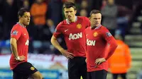 Reaksi Wayne Rooney dkk usai Manchester United tertinggal dari Wigan Athletic 0-1 pada partai lanjutan Liga Premier di DW Stadium, 11 April 2012. AFP PHOTO/ANDREW YATES
