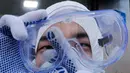 Petugas medis membersihkan kacamatanya saat akan menyemprotkan cairan disinfektan sebagai tindakan pencegahan virus corona (COVID-19) di Seoul, Korea Selatan, Kamis (27/2/2020). Dua kematian akibat virus corona kembali dilaporkan di Korea Selatan. (AP Photo/Ahn Young-joon)