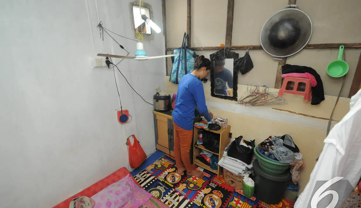 Ninih merapikan perabotan yang berada di kamar kontrakannya yang sederhana di daerah Pejompongan, Jakarta. Foto diambil pada Selasa (9/12/2014). (Liputan6.com/Herman Zakharia)