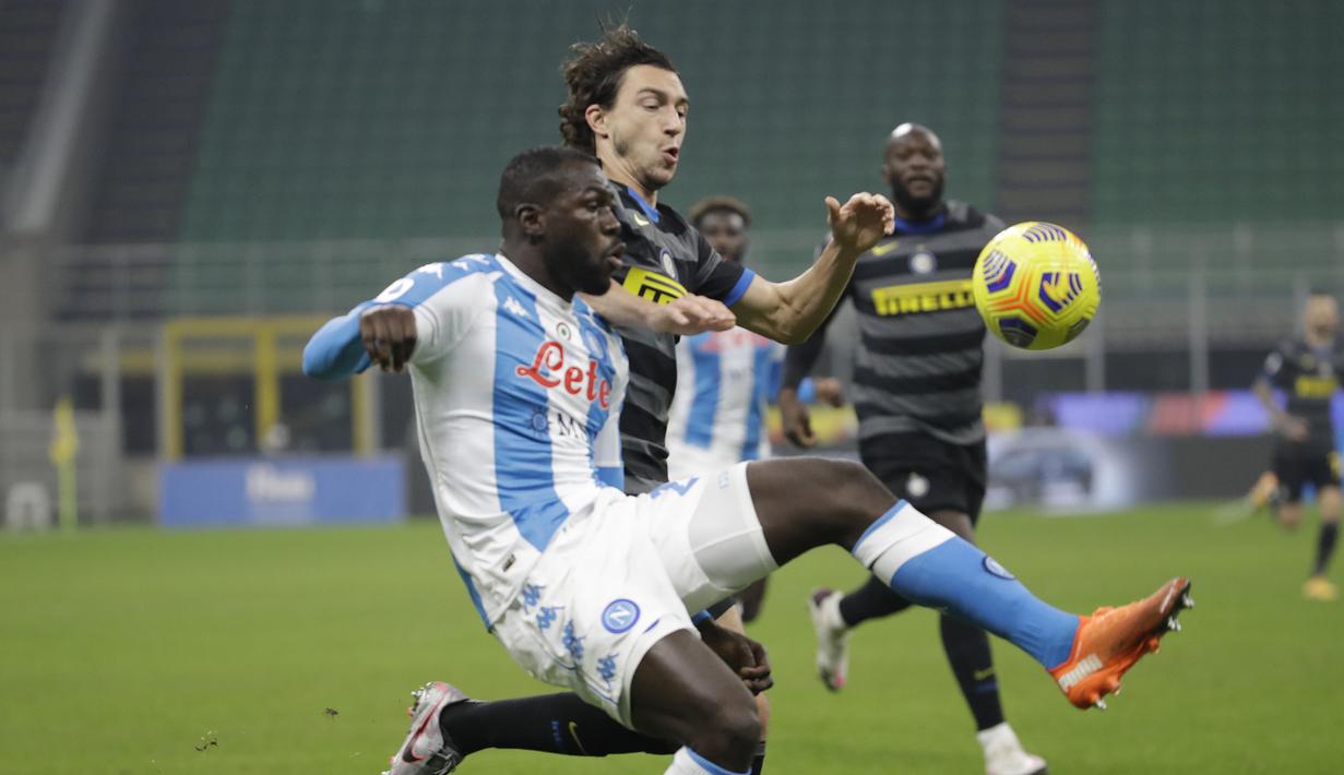 Bek Napoli, Kalidou Koulibaly (kiri), berebut bola dengan bek Inter Milan, Matteo Darmian, dalam laga lanjutan Liga Italia 2020/21 Serie A pekan ke-12 di San Siro Stadium, Rabu (16/12/2020). Napoli kalah 0-1 dari Inter. (AP/Luca Bruno)