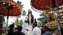 Sejumlah warga menyiapkan arak-arakan Bade atau menara bertingkat sembilan yang berisi jenazah anggota keluarga dari pahlawan nasional I Gusti Ngurah Rai dalam prosesi upacara Ngaben di Desa Carangsari, Badung, Bali, Senin (29/4/2019). (SONNY TUMBELAKA/AFP)