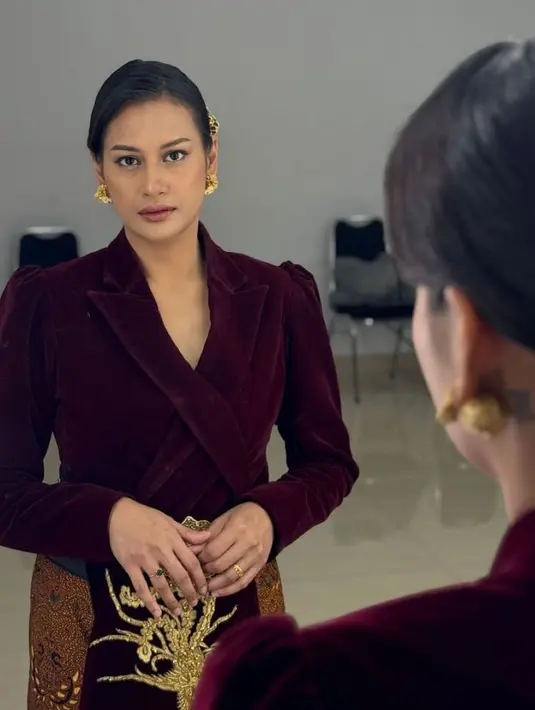 Raihaanun tampil dengan kebaya modifikasi maroon berbahan velvet dipadukan kain batik coklat sebagai bawahan. Dan anting-anting subeng keemasan. [@raihaanun]