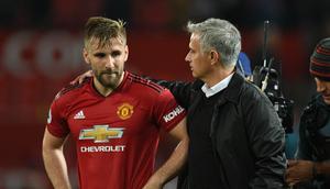 Pelatih Manchester United, Jose Mourinho merangkul bek Luke Shaw usai pertandingan melawan Tottenham Hotspur pada lanjutan Liga Inggris di Old Trafford, (27/8). MU kalah telak atas tottenham 3-0. (AFP Photo/Oli Scarff)