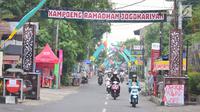 Pengendara melintasi gapura "Kampoeng Ramadhan Jogokariyan" di Jalan Jogokaryan Yogyakarta, Senin (21/5). Kampoeng Ramadhan Jogokaryan adalah salah satu program dari masjid Jogokariyan untuk menyemarakan bulan suci Ramadan. (Liputan6.com/Gholib)