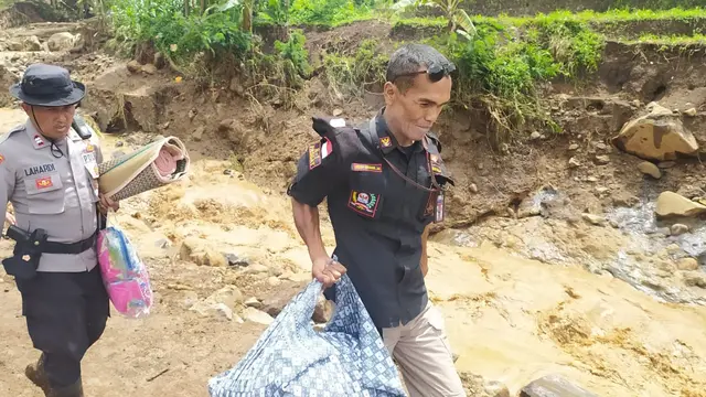 Petugas kepolisian resort Garut nampak sigap memberikan bantuan bagi warga terdampak banjir bandang Kecamatan karangtengah. Garut.