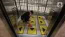 Petugas membersihkan lift yang dipasangi garis batas setiap pengguna di Senayan City, Jakarta, Selasa (9/6/2020). Senayan City siap menyambut pengunjung kembali pada 15 Juni 2020 dengan menyediakan sensor tanpa sentuh untuk lift hingga hand sanitizer di beberapa titik. (Liputan6.com/Johan Tallo)