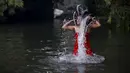 Wanita Hindu Nepal mandi suci disungai Salinadi saat Festival Swasthani Brata Katha di Katmandu, Nepal, (24/1). Selama festival ini, para wanita yang belum menikah berdoa untuk mendapatkan suami yang baik. (REUTERS/Navesh Chitrakar)