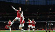 Gelandang Arsenal, Martin Odegaard (melompat), merayakan gol yang dicetaknya ke gawang Luton Town bersama rekan setimnya yang memberikan assist, Kai Havertz, dalam laga pekan ke-21 Premier League 2023/2024 di Emirates Stadium, Kamis (4/4/2024) dini hari WIB. Arsenal menang 2-0 dalam laga ini. (Adrian DENNIS / AFP)