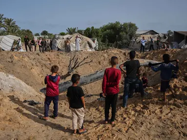 Warga Palestina memeriksa kerusakan akibat serangan Israel di Khan Younis, Jalur Gaza selatan, Selasa 19 Mei 2026. (AP Photo/Abdel Kareem Hana)