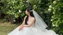 Kim Ji Won tampil super cantik mengenakan gaun pengantin putih dan veilnya yang menyempurnakan keseluruhan penampilannya di drama Queen of Tears. Di sini, Kim Ji Won membiarkan rambut hitam panjangnya tergerai, serasi dengan gaun pengantin tanpa lengan yang dikenakannya. [Foto: Instagram/geewonii]