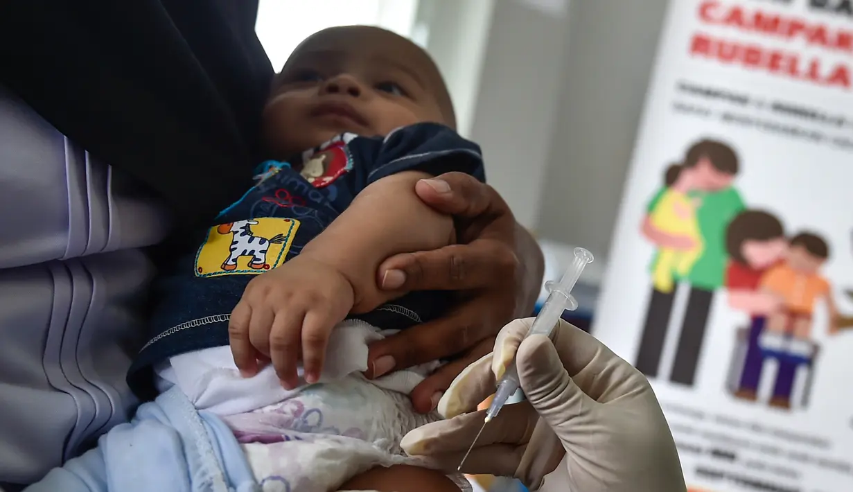 Petugas menyuntikan Vaksin Campak dan Rubella (MR) kepada bayi saat dilakukan imunisasi di sebuah puskesmas, Banda Aceh, Rabu (19/9). Pemprov Aceh akhirnya membolehkan pelaksanaan vaksinasi MR yang mengandung enzim babi. (CHAIDEER MAHYUDDIN / AFP)