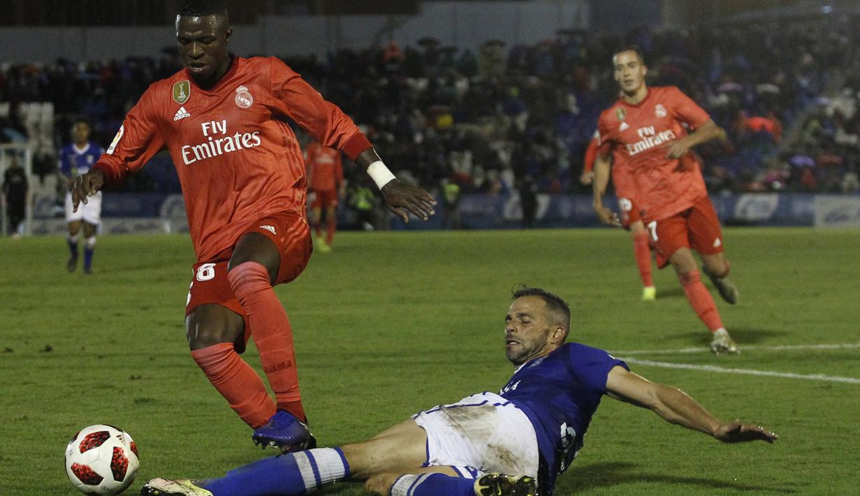 Penyerang Real Madrid, Vinicius Junior, berusaha melewati pemain UD Melilla pada laga Copa del Rey di Stadion Alvarez Claro, Melilla, Rabu (31/10/2018). Real Madrid menang 4-0 atas UD Melilla. (AP/Javier Gandul)