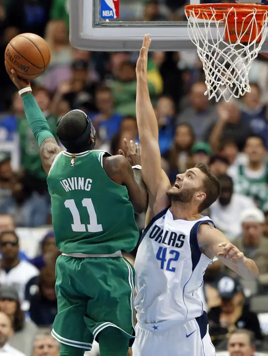 Aksi pemain Boston Celtics, Kyrie Irving (11) melakukan tembakan saat diadang pemain Dallas Mavericks, Maximilian Kleber (42) pada laga NBA basketball game di American Airlines Center, Dallas, (20/11/2017).   Celtics menang 110-102. (AP/Tony Gutierrez)