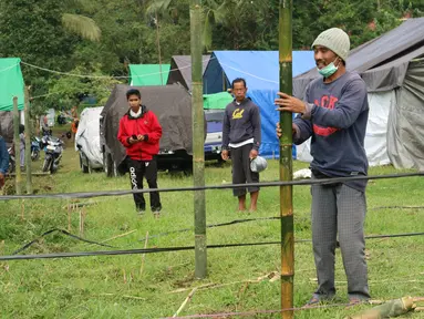 Warga membangun kamp pengungsian Gunung Agung di lahan milik dinas pertanian, Karangasem, Bali, Senin (27/11). Status Gunung Agung yang naik dari siaga ke awas, membuat warga diminta mengungsi dari radius 8 hingga 10 kilometer. (Liputan6.com/Andi Jatmiko)