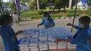 Mahasiswa menyiapkan makanan gratis untuk masyarakat di UKI, Cawang, Jakarta, Selasa (16/3/2021). Kegiatan ini memberikan 500 bungkus nasi, masker dan vitamin setiap harinya sejak pukul 06.00 WIB, untuk meringankan beban masyarakat di masa pandemi Covid-19. (Liputan6.com/Herman Zakharia)