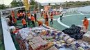 Percepatan distribusi pasokan ini untuk mengatasi menipisnya stok logistik di beberapa daerah. Tampak dalam foto, personel Badan Nasional Pencarian dan Pertolongan (Basarnas) sedang memuat bantuan yang disumbangkan untuk korban banjir bandang di permukiman warga di Banda Aceh, Provinsi Aceh, pada 1 Desember 2025. (Chaideer MAHYUDDIN/AFP)