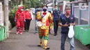 Komunitas Badut Tangerang  Raya (Batara) membagikan paket masker dan sabun cuci tangan gratis kepada warga di Larangan Selatan, Tangerang, Kamis (16/4/2020). PMI Kota Tangerang bersama Batara membagikan masker dan sabun cuci tangan untuk mencegah penyebaran COVID-19. (Liputan6.com/Angga Yuniar)