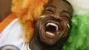 Ekspresi bahagia suporter Pantai Gading saat timnya memenangan Piala Afrika 2023 di Alassane Ouattara Olympic Stadium, Ebimpe, Abidjan, Pantai Gading, Minggu (11/02/2024) waktu setempat. (AFP/Daniel Beloumou Olomo)