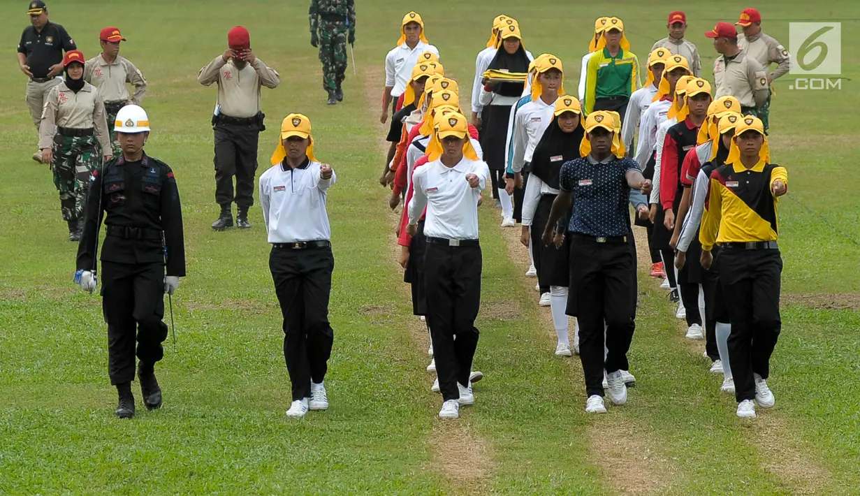 Sejumlah calon Paskibraka melakukan latihan berbaris sambil membawa bendera latihan di PPPON, Cibubur, Jakarta, Senin (31/7). Memasuki hari ke-7, calon Paskibraka matangkan latihan menaikan bedera. (Liputan6.com/Yoppy Renato)