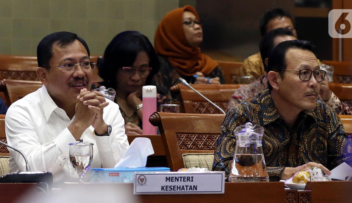 Menteri Kesehatan Terawan Agus Putranto (kiri) dan Dirut BPJS Kesehatan Fachmi Idris (kanan) saat rapat dengar pendapat dengan Komisi IX DPR di Kompleks Parlemen, Jakarta, Selasa (5/11/2019). Rapat membahas polemik kenaikan iuran BPJS Kesehatan. (Liputan6.com/JohanTallo)
