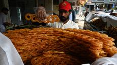 Seorang tukang roti menyiapkan makanan buka puasa Jalebi di sebuah toko di Islamabad, Pakistan, Kamis (23/3/2023). (Aamir QURESHI/AFP)