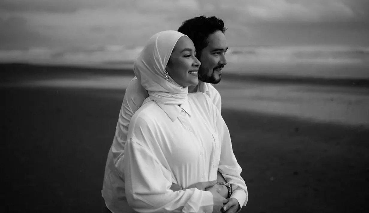 Selalu hangat dan jauh dari gosip miring, pasangan artis satu ini tak lepas dari perhatian dan kerap tuai pujian dari publik. Momen romantis yang diunggah di media sosial berhasil membuat warganet terbawa perasaan. Kenakan baju warna putih senada saat pemotretan, pasangan suami istri ini makin manis. (Liputan6.com/IG/@aryanifitriana24)