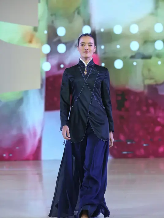 Mawar Eva de Jongh tampil mengenakan kebaya janggan hitam dengan kerah layering putih. Kebaya memili aksen beads warna biru senada dengan rok panjang flowlynya. [Adrian/Fimela]