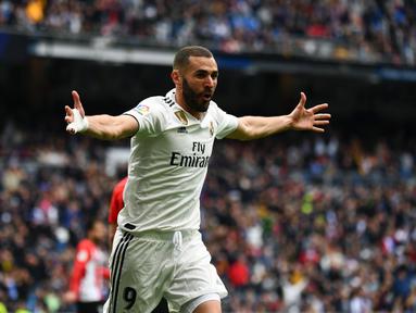 Selebrasi Karim Benzema pada laga lanjutan La Liga di pekan ke-33 yang berlangsung di Stadion Santiago Bernabeu, Madrid Minggu (21/4). Real Madrid menang 3-0 atas Bilbao. (AFP/Gabriel Bouys)
