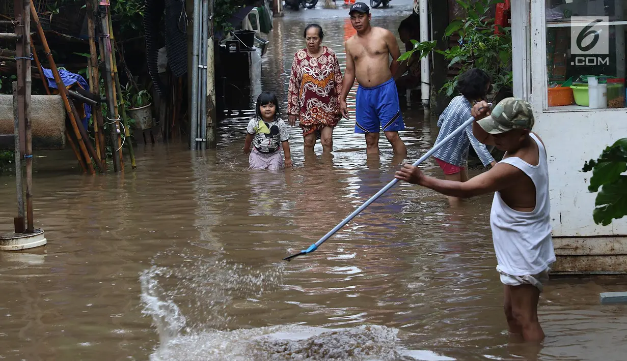 Warga membersihkan banjir yang menggenangi kawasan Cilandak Timur, Jakarta Selatan, Selasa (22/1). Hujan deras yang mengguyur Jakarta dan sekitarnya sejak pagi menyebabkan banjir di sejumlah sudut Ibu Kota. (Liputan6.com/Immanuel Antonius)